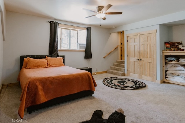 carpeted bedroom featuring a closet and ceiling fan