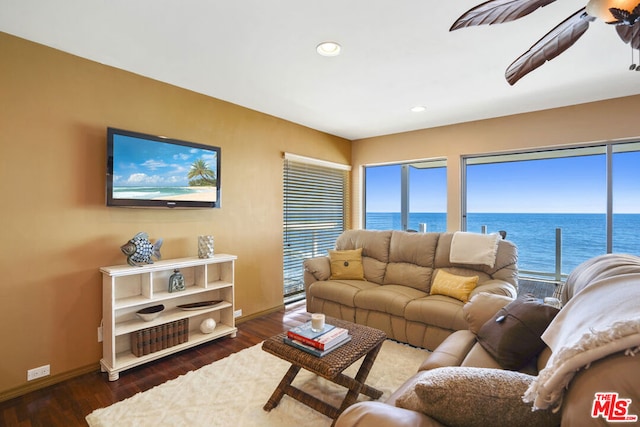 living room featuring ceiling fan and dark hardwood / wood-style flooring