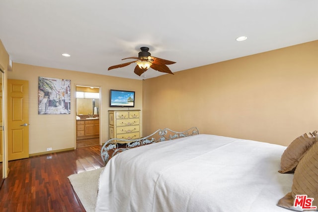 bedroom featuring ensuite bath, dark wood-type flooring, and ceiling fan