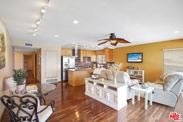 living room featuring ceiling fan and dark hardwood / wood-style floors