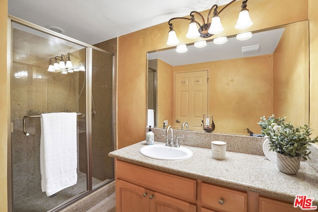 bathroom with vanity and an enclosed shower