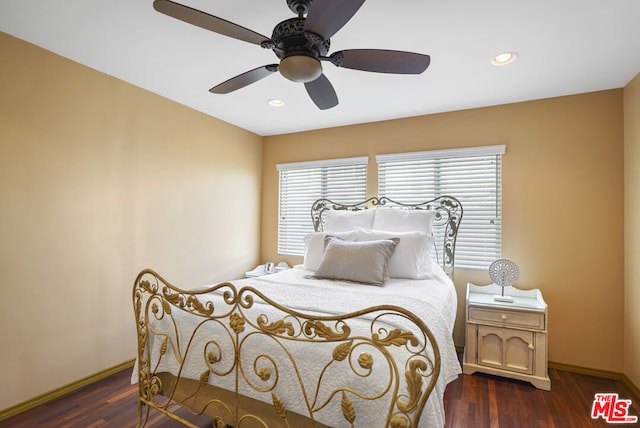 bedroom with dark hardwood / wood-style floors and ceiling fan