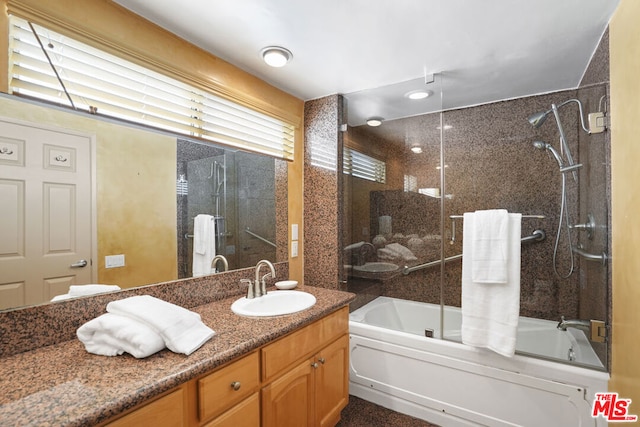 bathroom featuring vanity and enclosed tub / shower combo