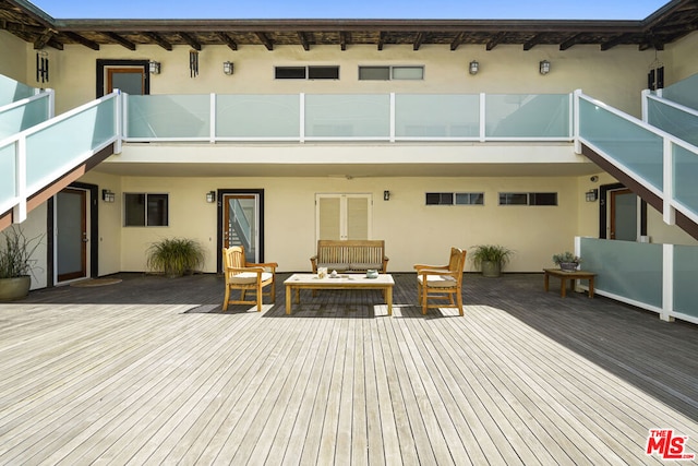 back of property with a wooden deck and outdoor lounge area