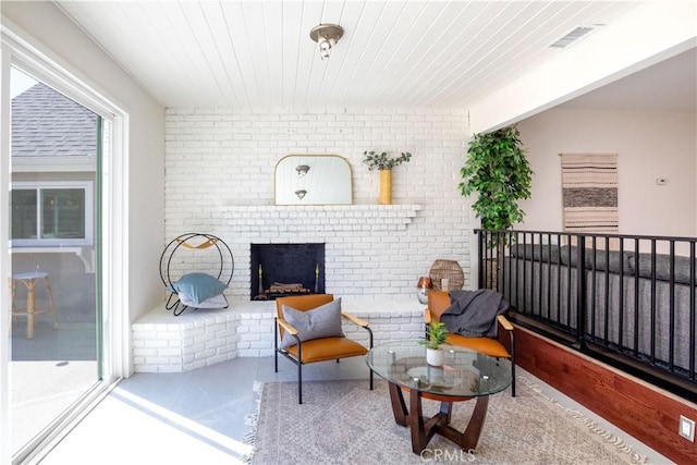 interior space featuring wood ceiling and brick wall