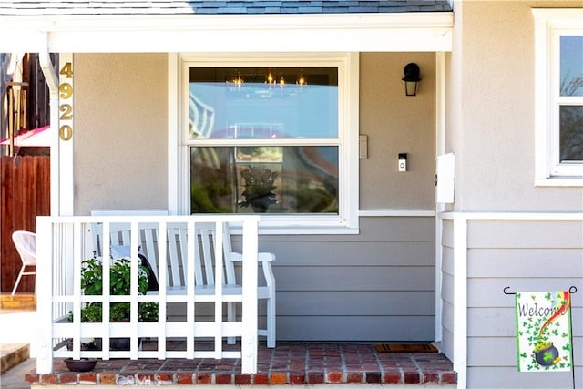 property entrance with covered porch