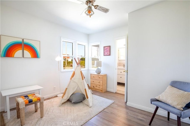 rec room with wood-type flooring and ceiling fan