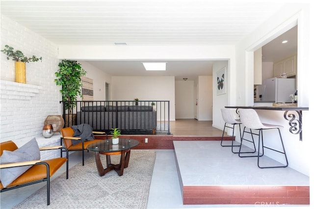 living room featuring brick wall