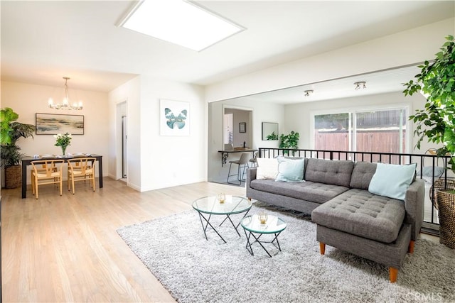 living room featuring light hardwood / wood-style floors and a chandelier