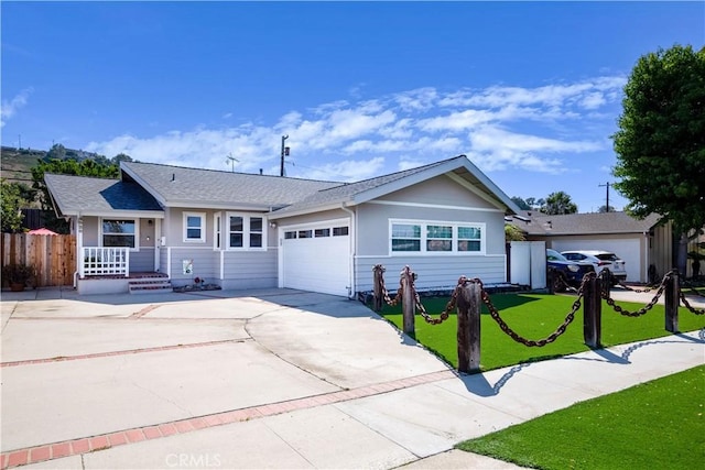 ranch-style house featuring a garage, covered porch, and a front lawn