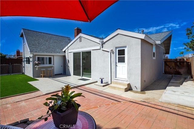 rear view of property featuring a patio