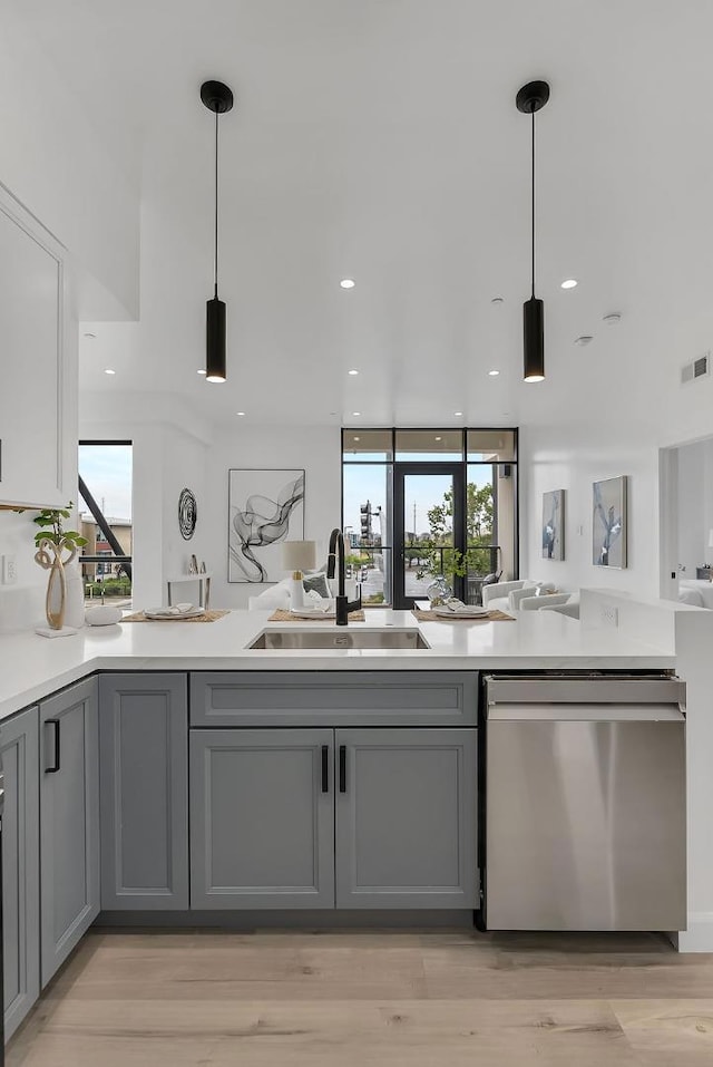 kitchen featuring sink, pendant lighting, dishwasher, and gray cabinetry