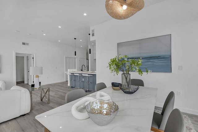 dining room featuring sink and hardwood / wood-style floors