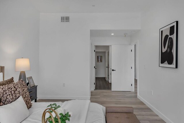 bedroom with light hardwood / wood-style floors