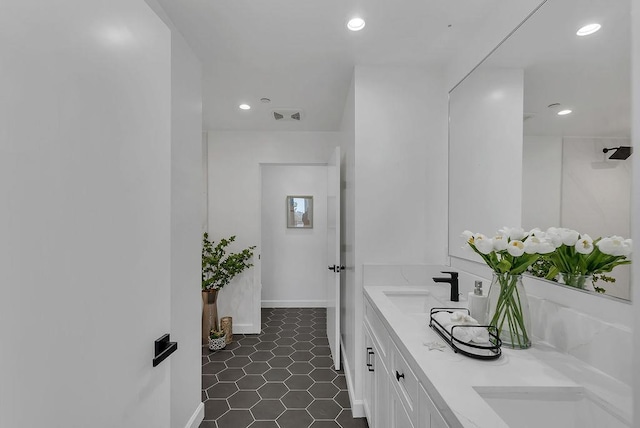 bathroom with tile patterned floors and vanity