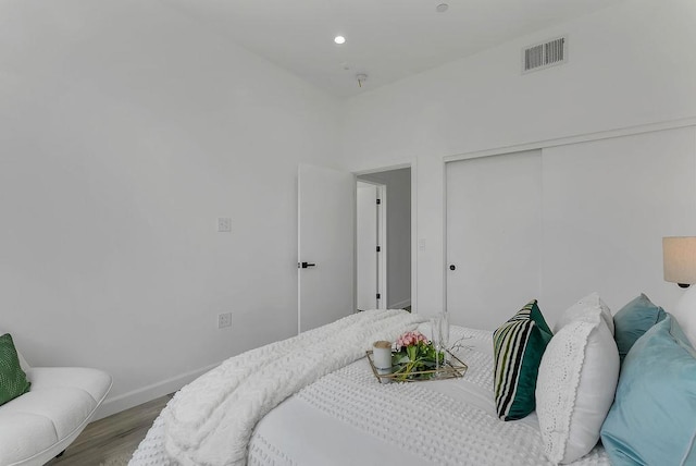 bedroom featuring a closet and light hardwood / wood-style flooring