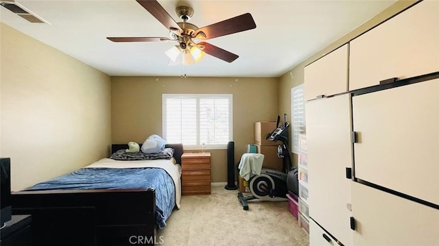 bedroom with ceiling fan and light colored carpet