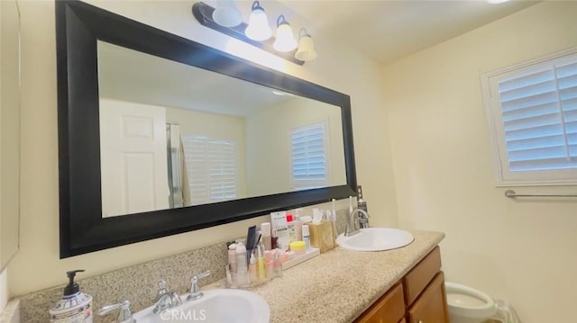 bathroom with vanity, an enclosed shower, and toilet