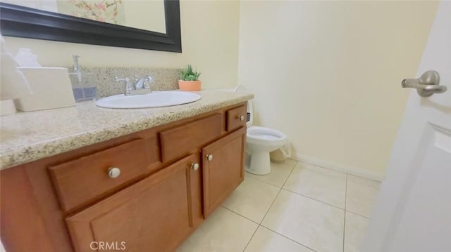 bathroom featuring toilet, vanity, and tile patterned floors