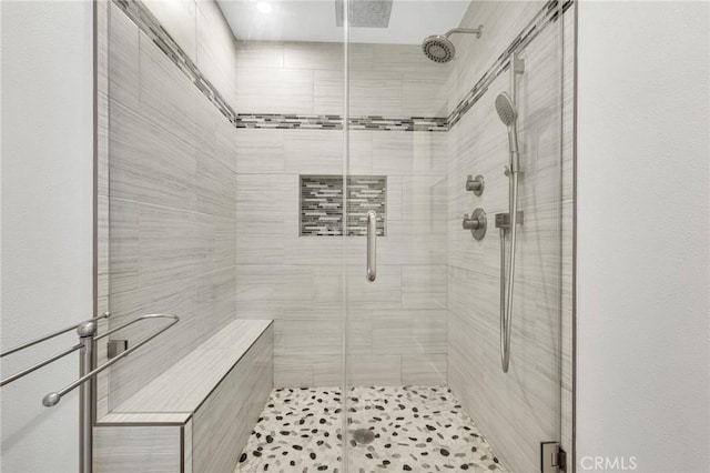 bathroom featuring a shower with shower door