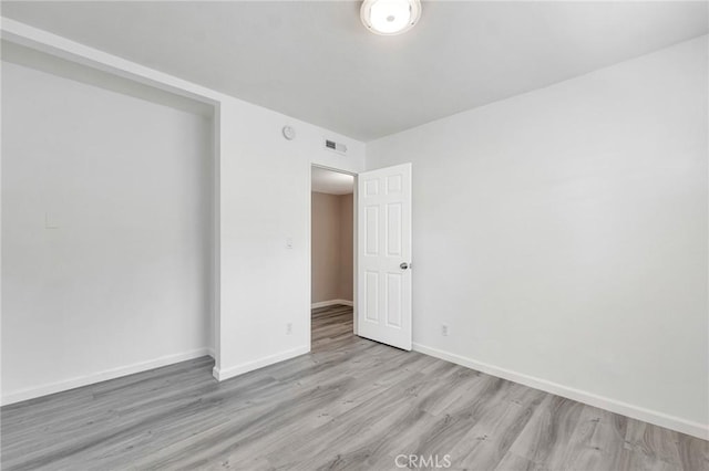 unfurnished room featuring light wood-type flooring