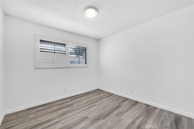 spare room featuring light wood-type flooring