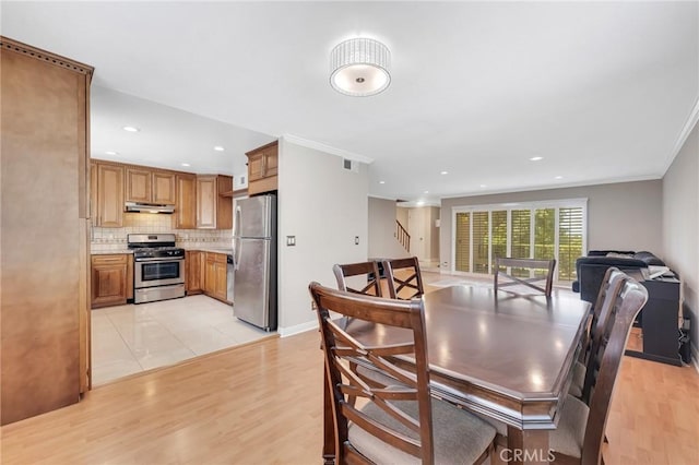 dining area featuring light hardwood / wood-style floors and ornamental molding