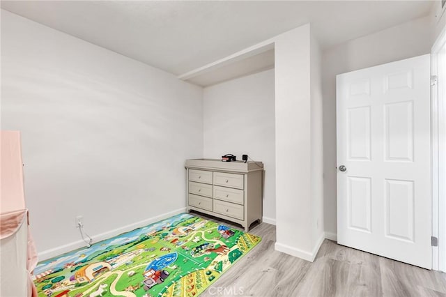 playroom with light hardwood / wood-style flooring