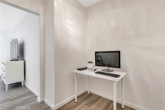 home office with light hardwood / wood-style flooring