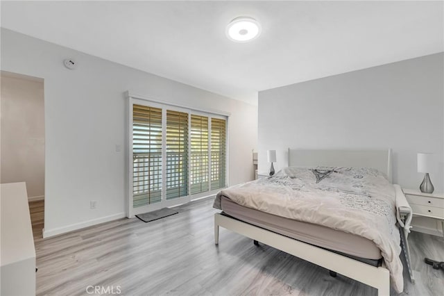 bedroom featuring access to exterior and light hardwood / wood-style floors