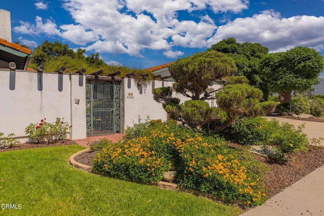 exterior space with a gate and a fenced front yard