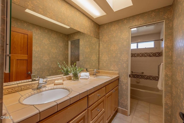 full bath featuring double vanity, a sink, shower / tub combination, and tile patterned floors