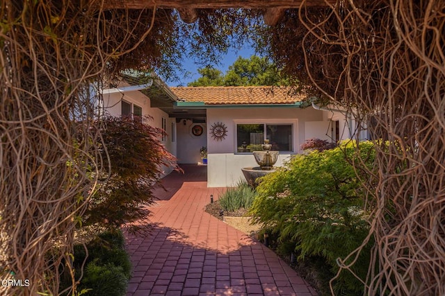 view of front of property with stucco siding and a tiled roof