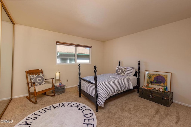 bedroom featuring baseboards and carpet floors