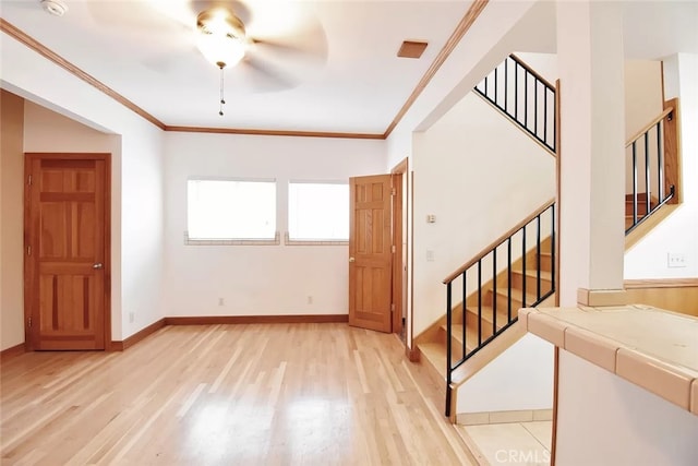 interior space with light hardwood / wood-style floors, ceiling fan, and ornamental molding