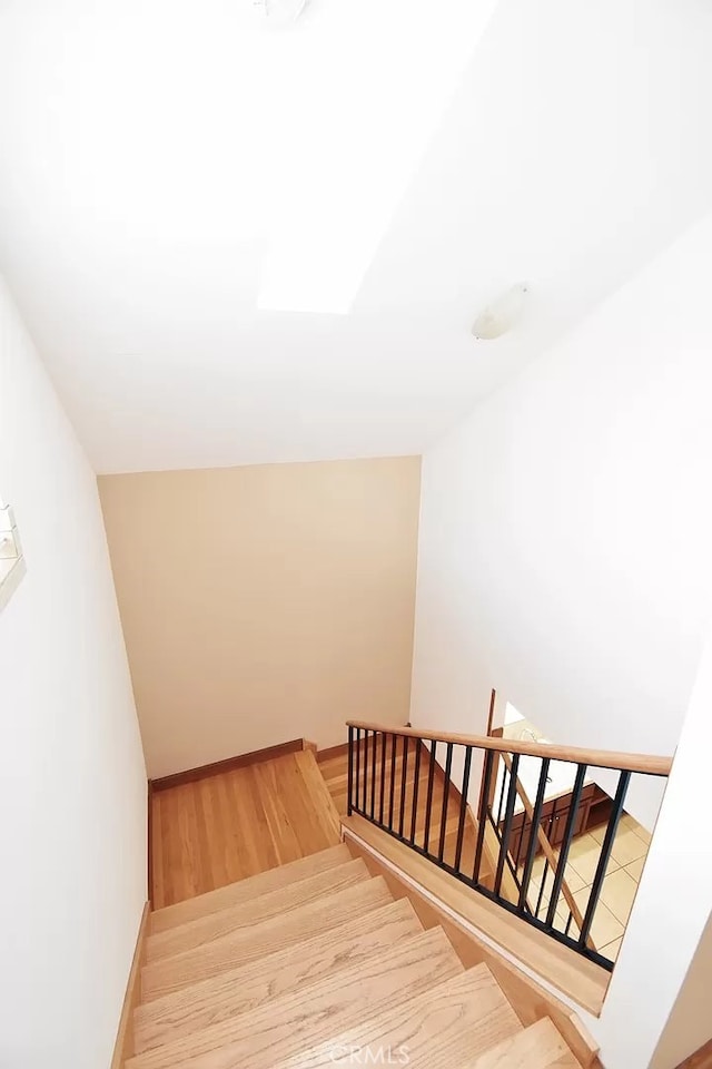 stairway featuring wood-type flooring