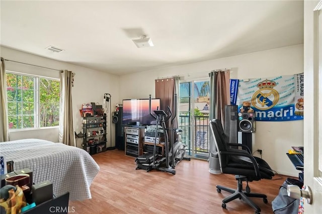 bedroom with hardwood / wood-style flooring