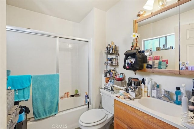 full bathroom featuring shower / bath combination with glass door, vanity, and toilet