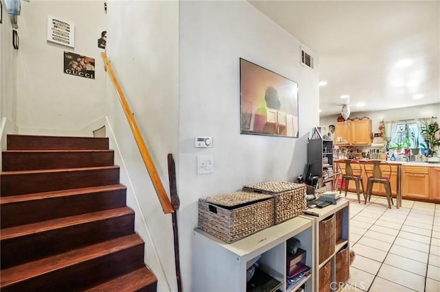 staircase featuring tile patterned flooring