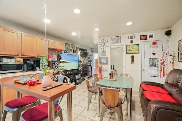 kitchen featuring light brown cabinetry and light tile patterned floors