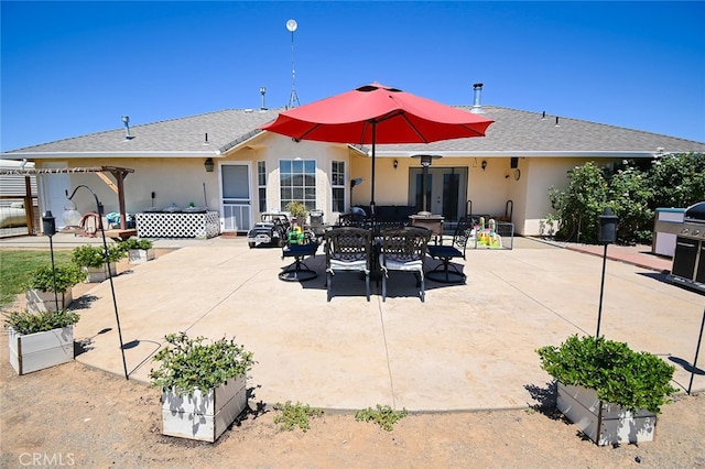 rear view of property featuring a patio