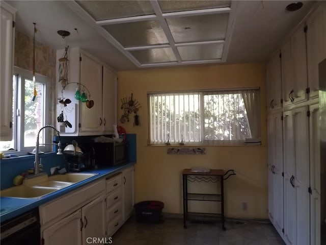 kitchen with dishwasher, decorative light fixtures, and sink