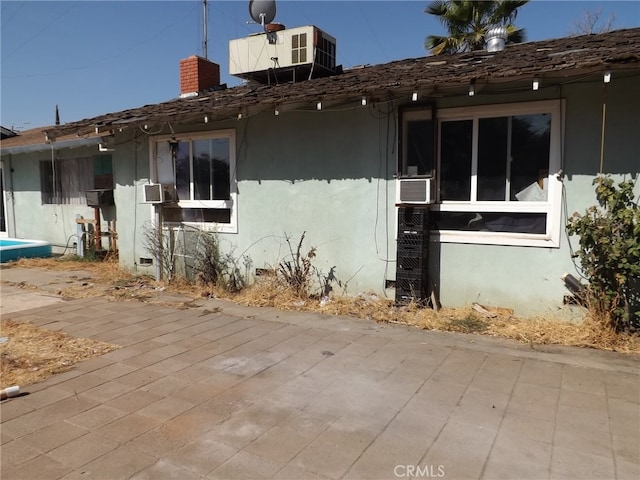 exterior space featuring cooling unit and a patio area