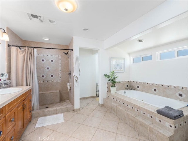 bathroom featuring tile patterned flooring, vanity, and separate shower and tub