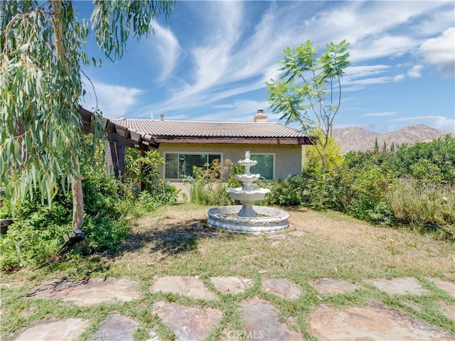 rear view of house featuring a mountain view