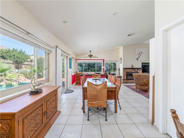 dining space featuring vaulted ceiling, ceiling fan, and light tile patterned flooring