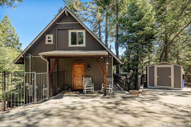 view of front of home featuring a storage shed