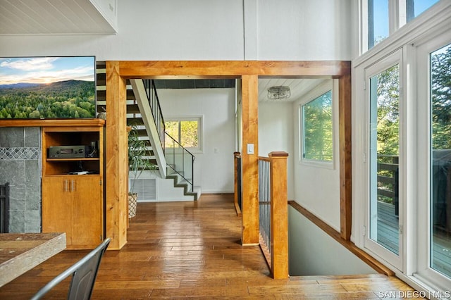 doorway with hardwood / wood-style flooring and a tile fireplace