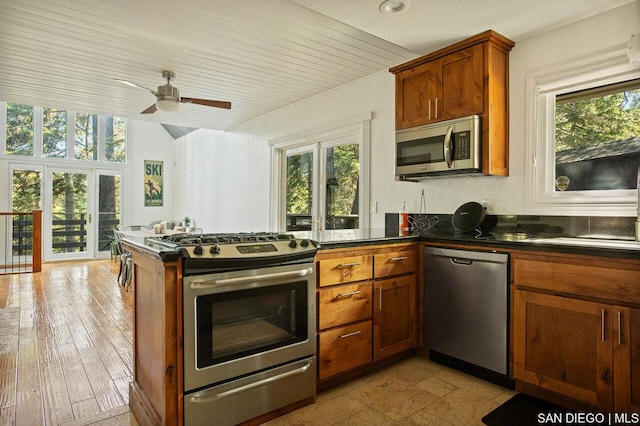 kitchen with ceiling fan, appliances with stainless steel finishes, lofted ceiling, and wood ceiling