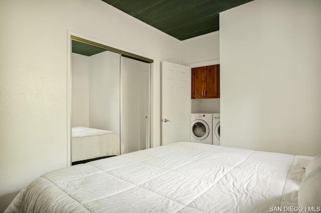 bedroom featuring a closet and washer and dryer